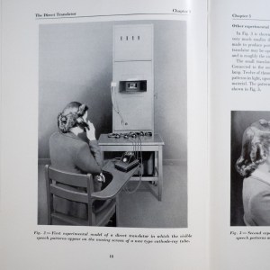 Operator sitting at a table in front of a large box with a tiny screen on it